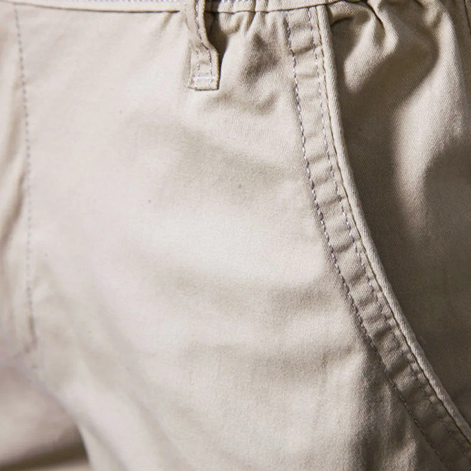Knee-length chino shorts with a button closure, belt loops, side pockets, and rolled hems.