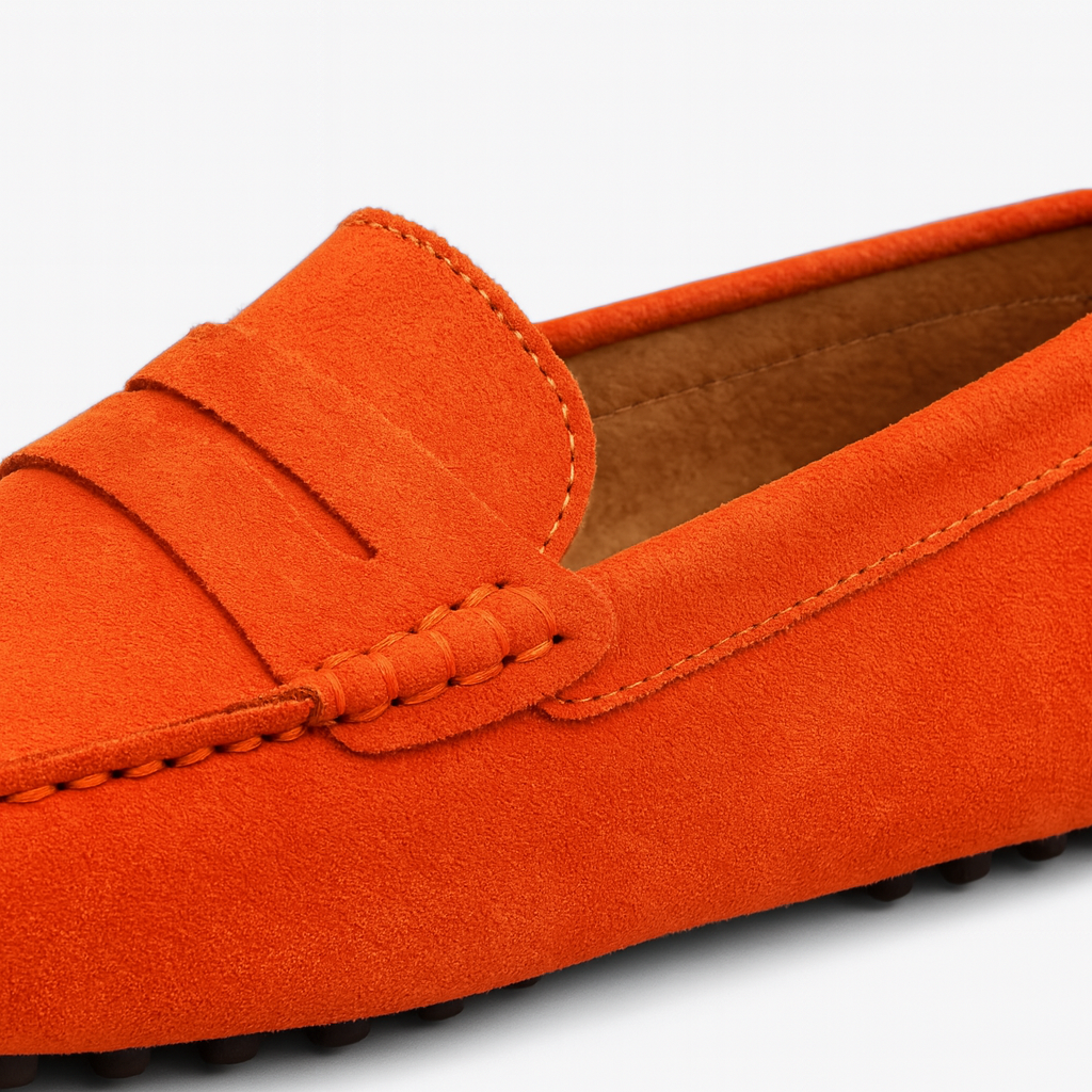 Suede driving loafer with a moccasin toe, penny strap detail, and rubber studded sole.