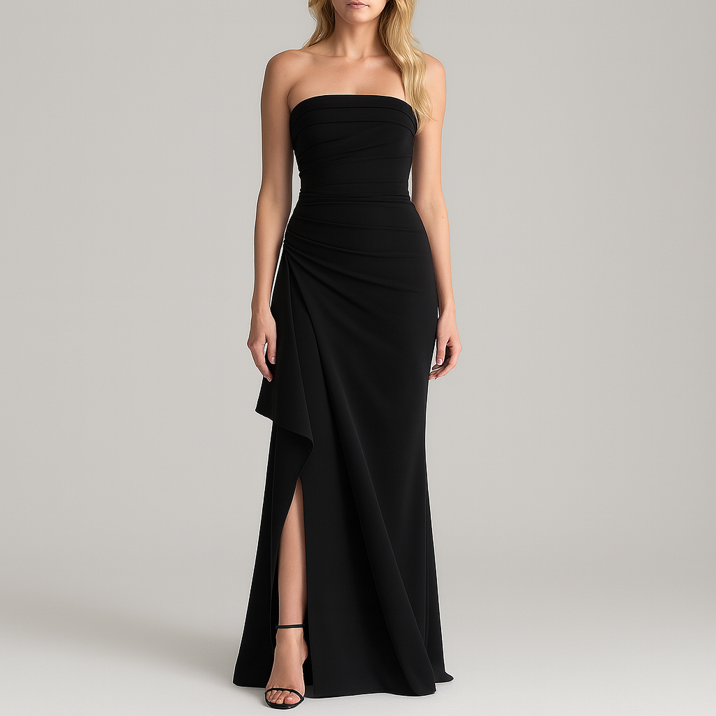 Strapless evening gown with ruched detailing and a high front slit, styled with heels and minimal jewelry.