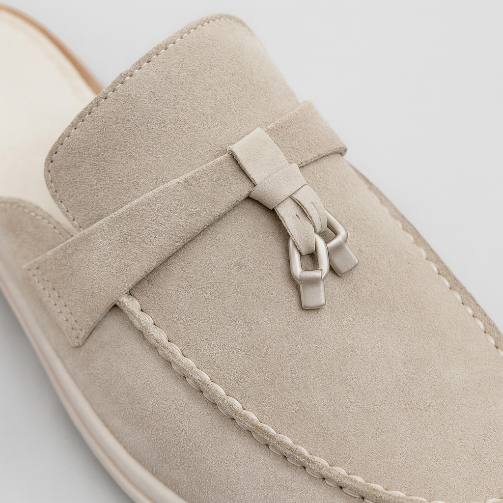 Stylish suede slip-on loafers featuring tassel accents and a low-heel design with contrast soles.