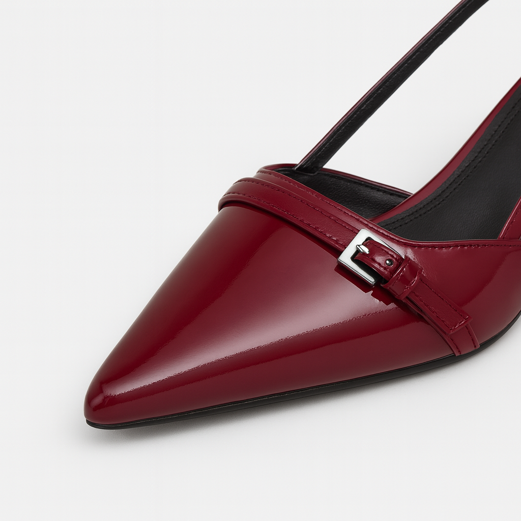 A pointed-toe slingback heel with a buckle detail and a low block heel.